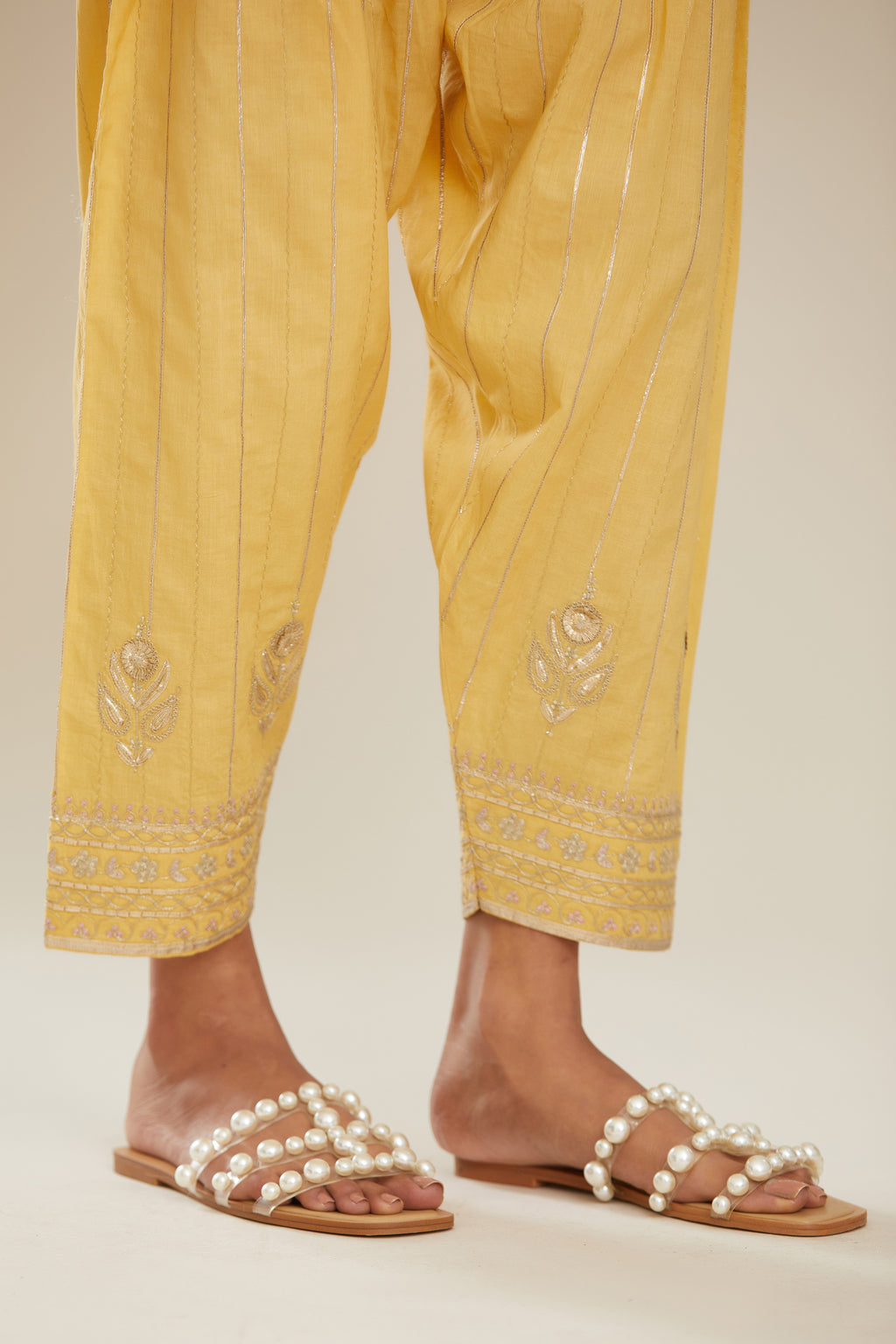 Yellow cotton narrow salwar with all-over gold gota and zari embroidery.
