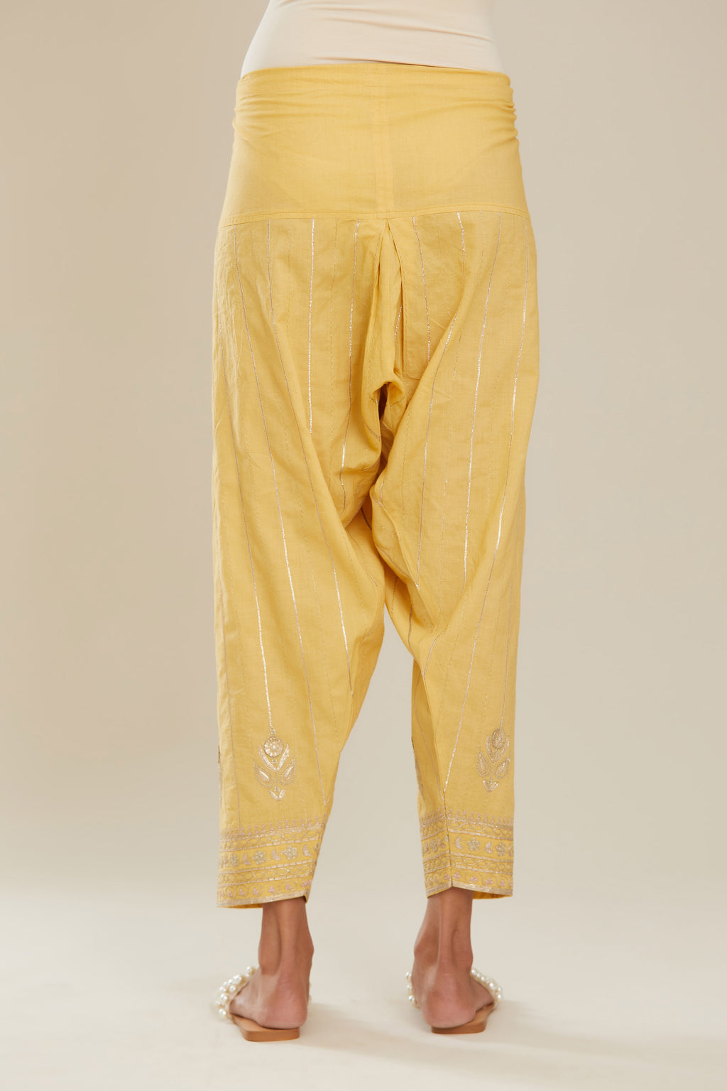 Yellow cotton narrow salwar with all-over gold gota and zari embroidery.