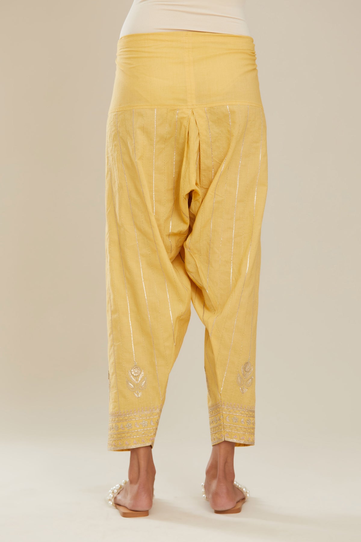 Yellow cotton narrow salwar with all-over gold gota and zari embroidery.