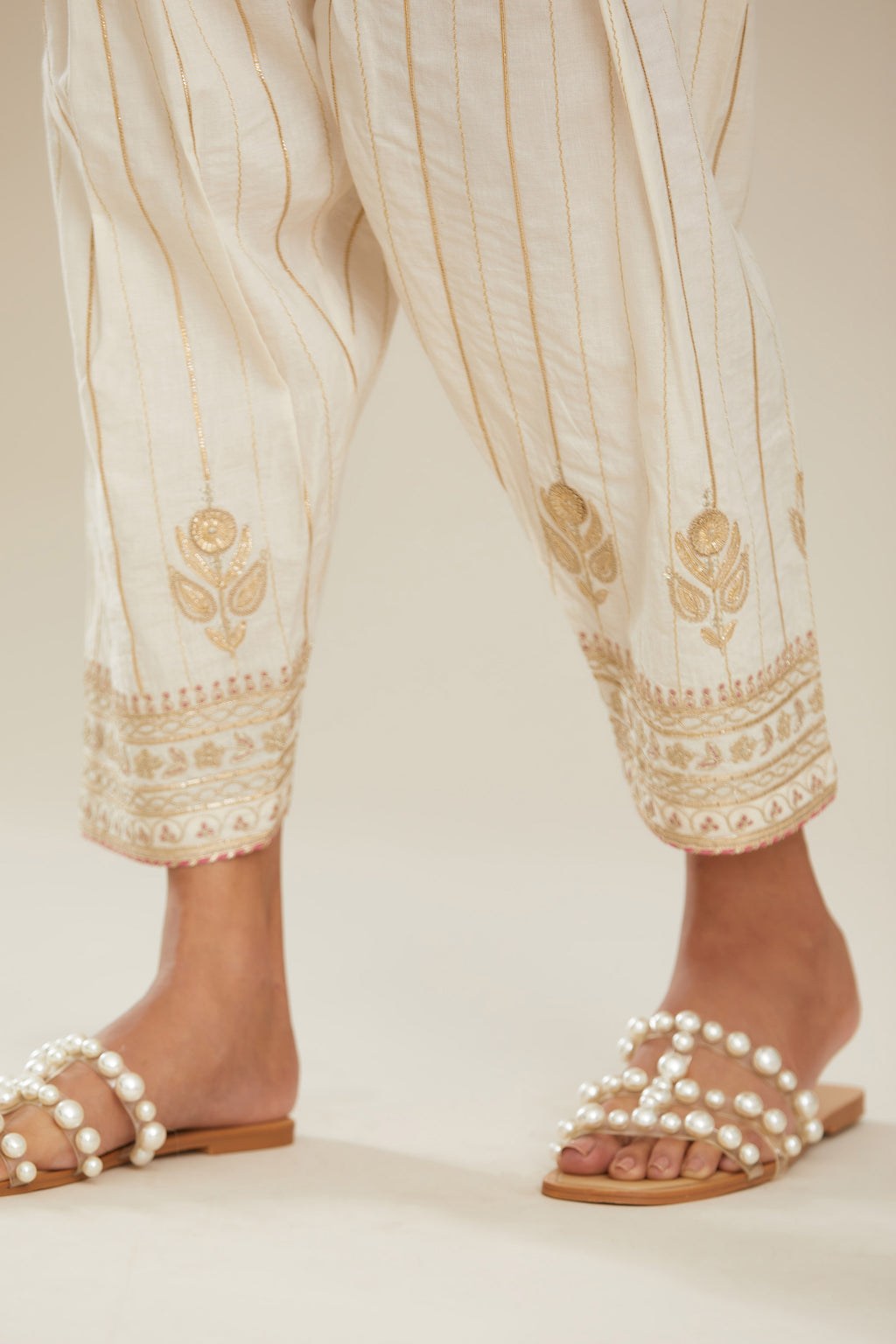Off white cotton narrow salwar with all-over gold gota and zari embroidery. (Salwar)
