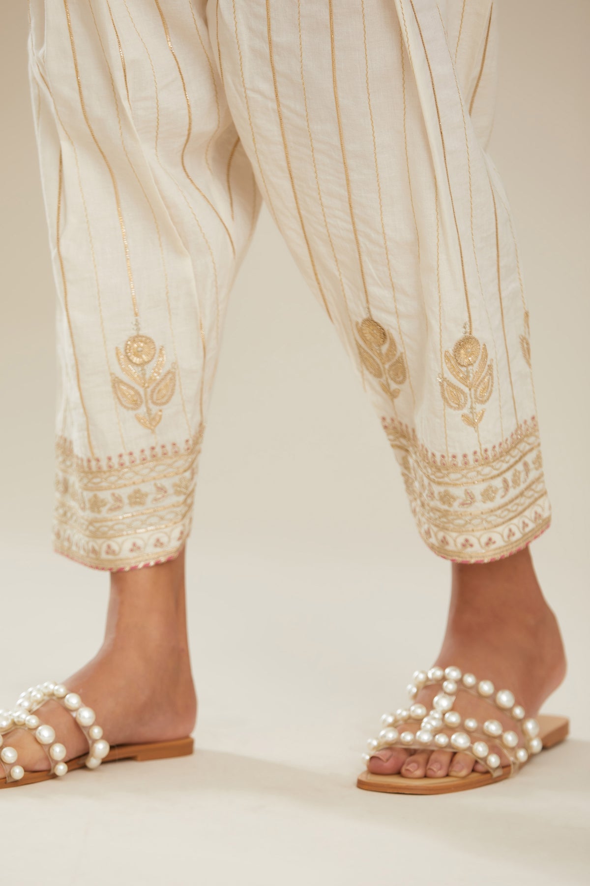Off white cotton narrow salwar with all-over gold gota and zari embroidery. (Salwar)