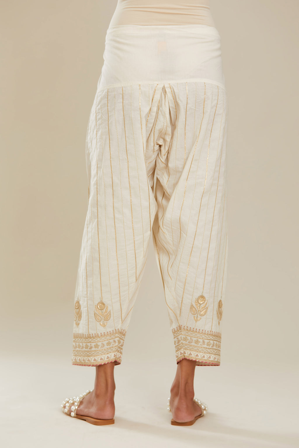Off white cotton narrow salwar with all-over gold gota and zari embroidery. (Salwar)
