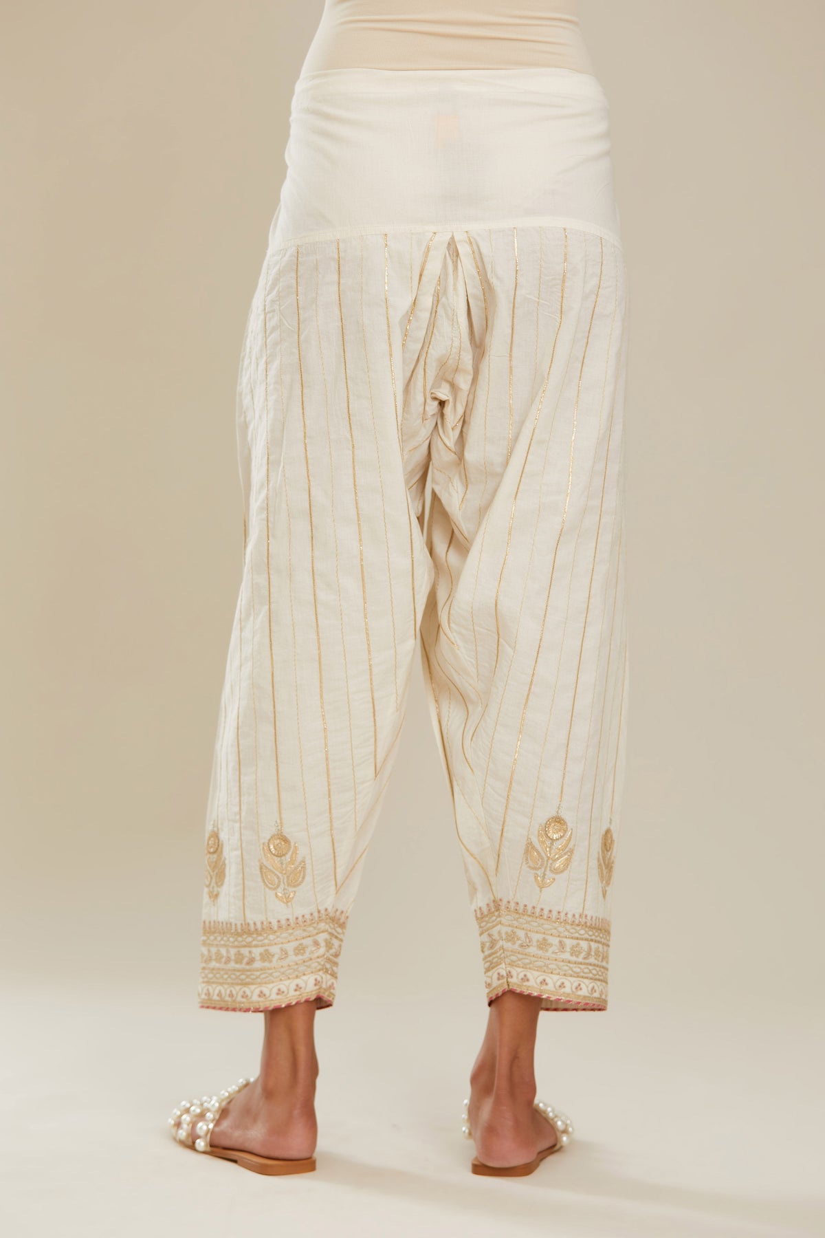 Off white cotton narrow salwar with all-over gold gota and zari embroidery. (Salwar)