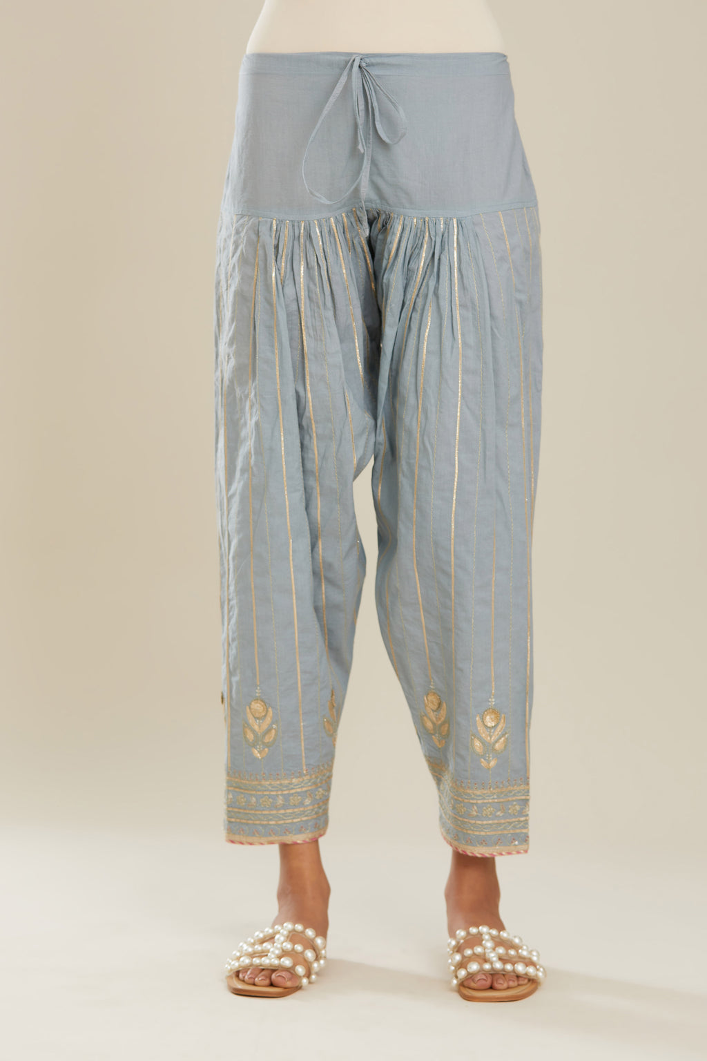 Powder blue cotton narrow salwar with all-over gold gota and zari embroidery.