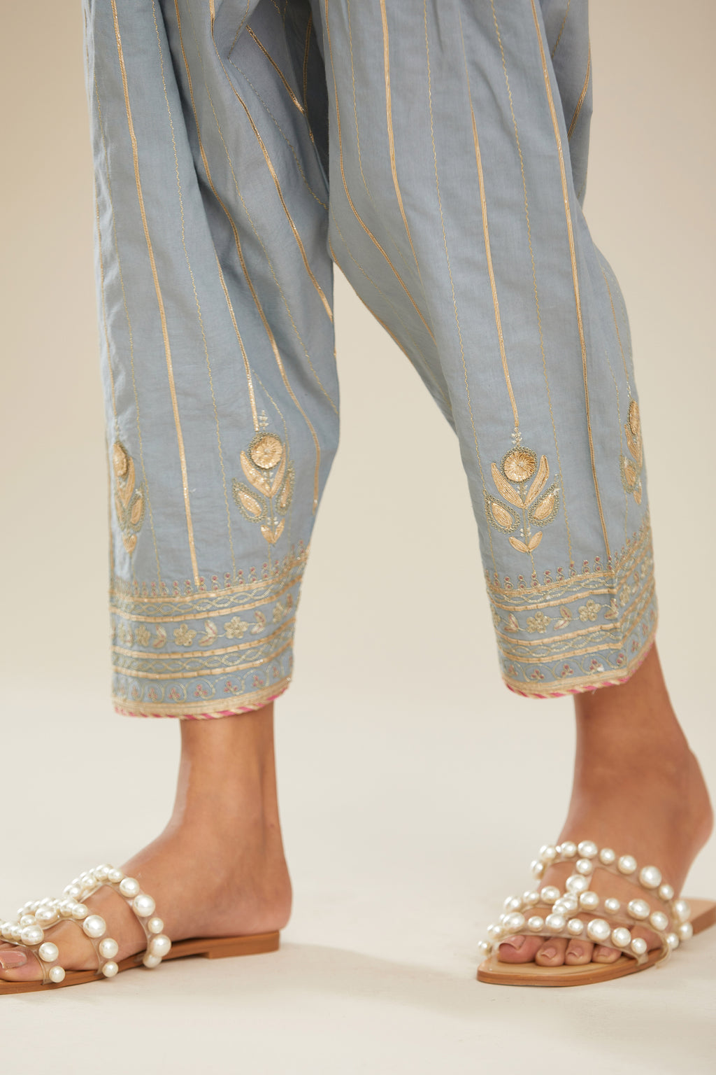 Powder blue cotton narrow salwar with all-over gold gota and zari embroidery.