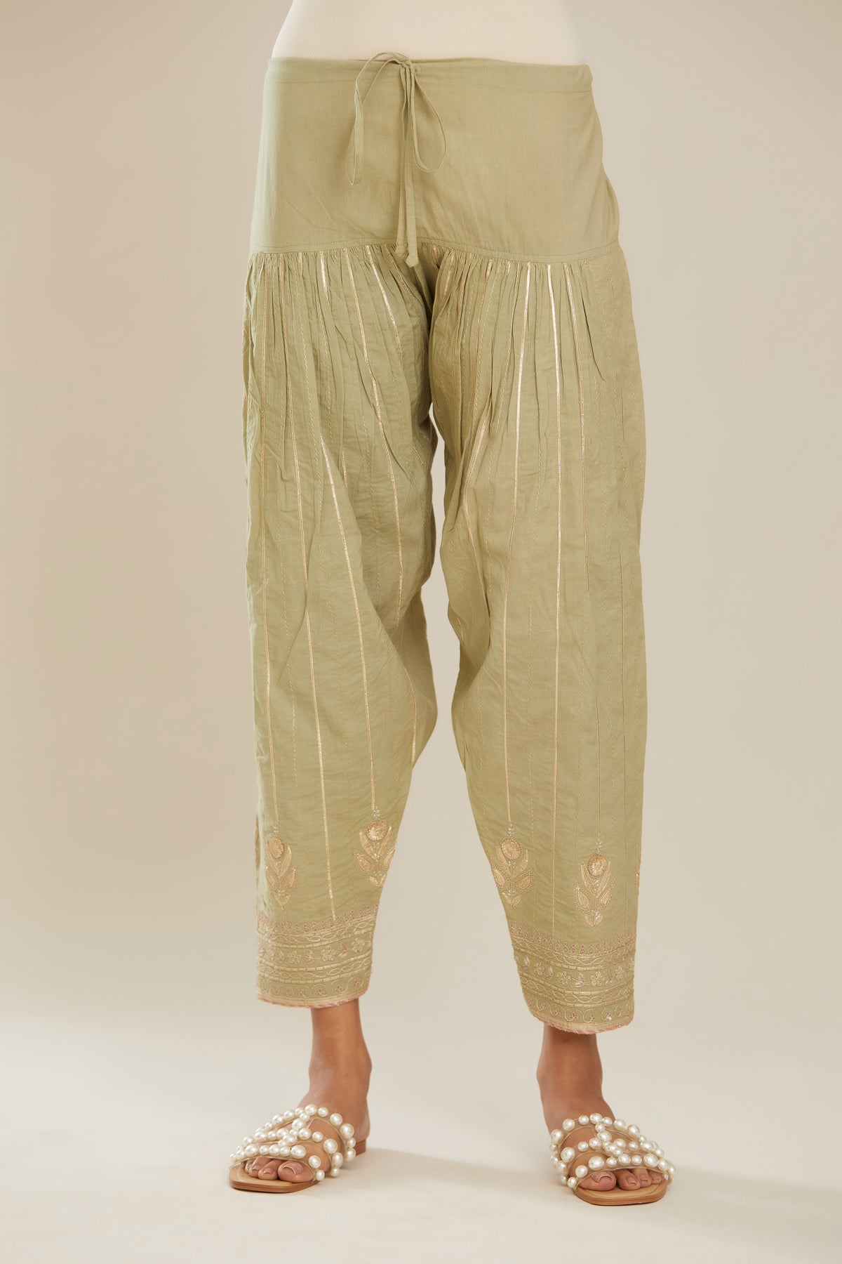 Sage green cotton narrow salwar with all-over gold gota and zari embroidery.