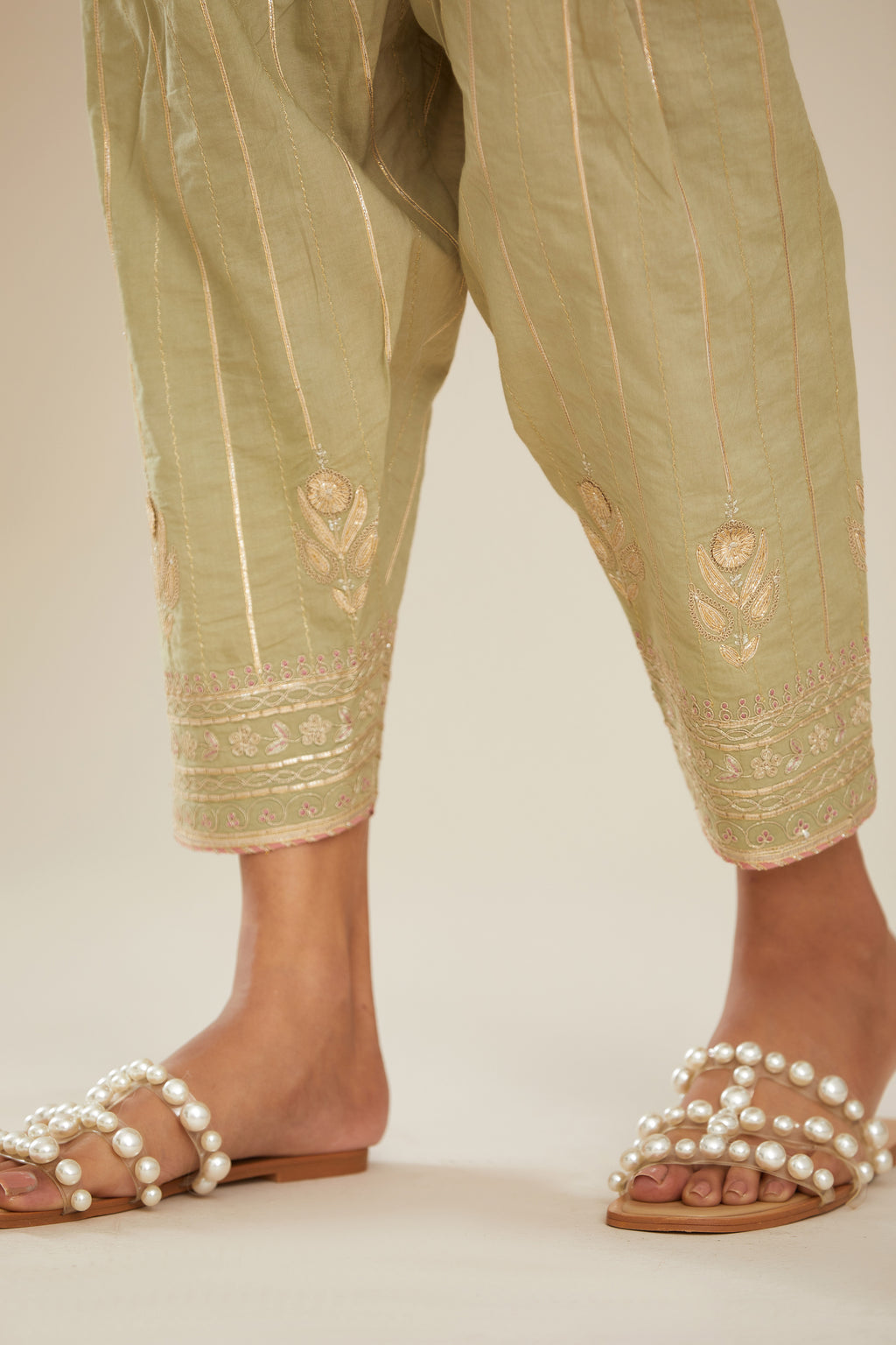 Sage green cotton narrow salwar with all-over gold gota and zari embroidery.