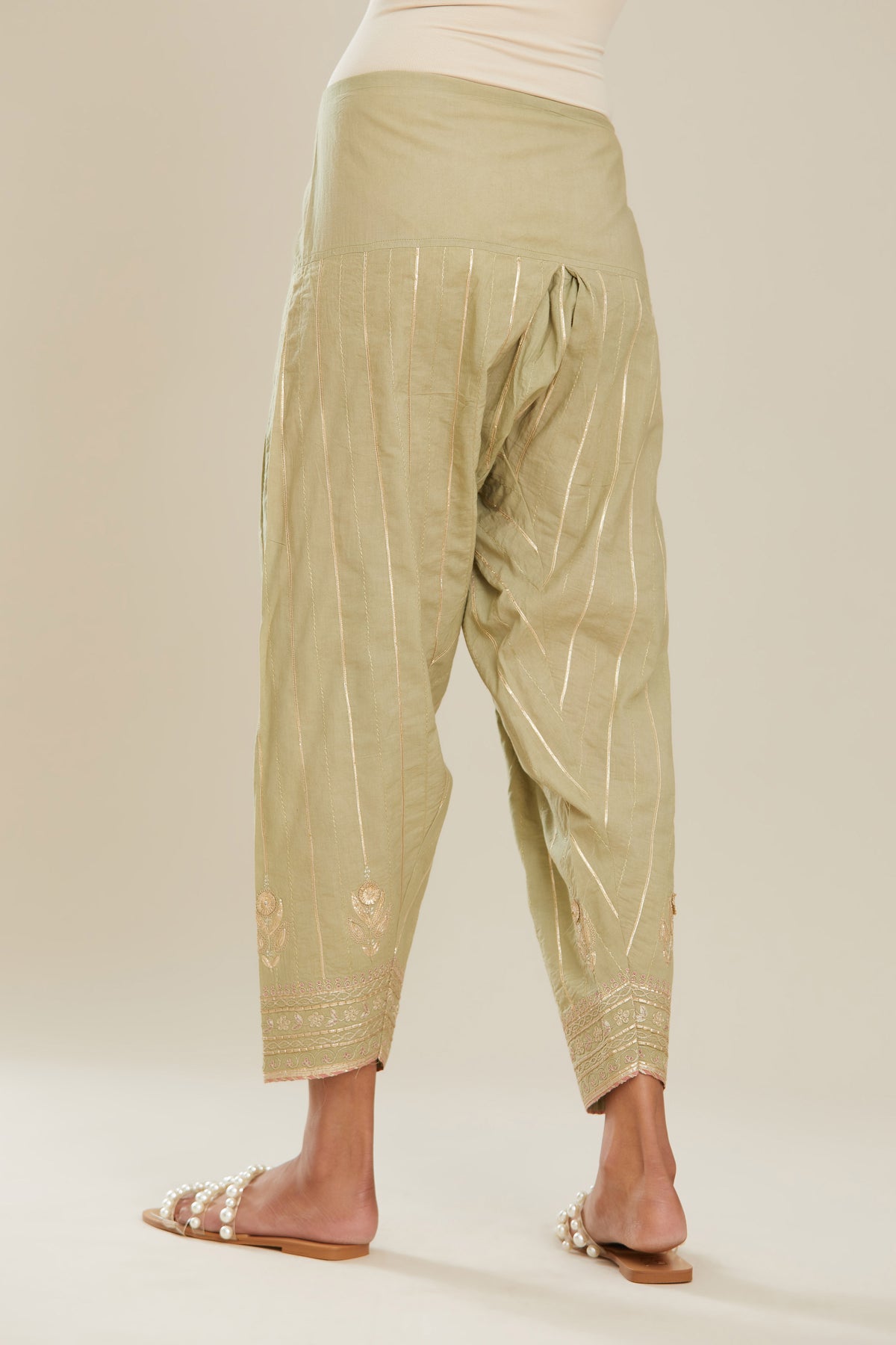 Sage green cotton narrow salwar with all-over gold gota and zari embroidery.