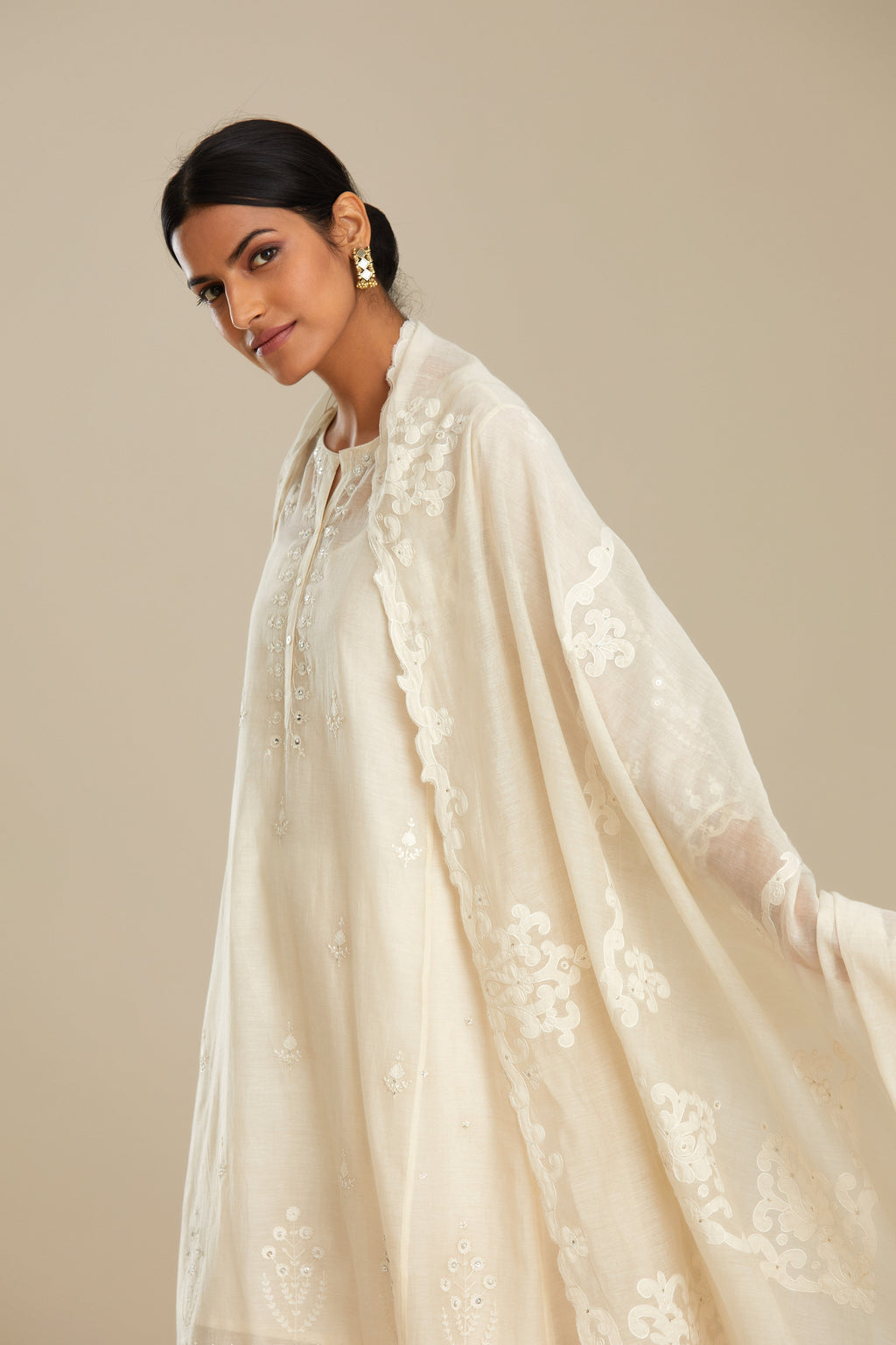 Off white cotton chanderi dupatta with cotton appliqué embroidery and sequin detail. (Dupatta)