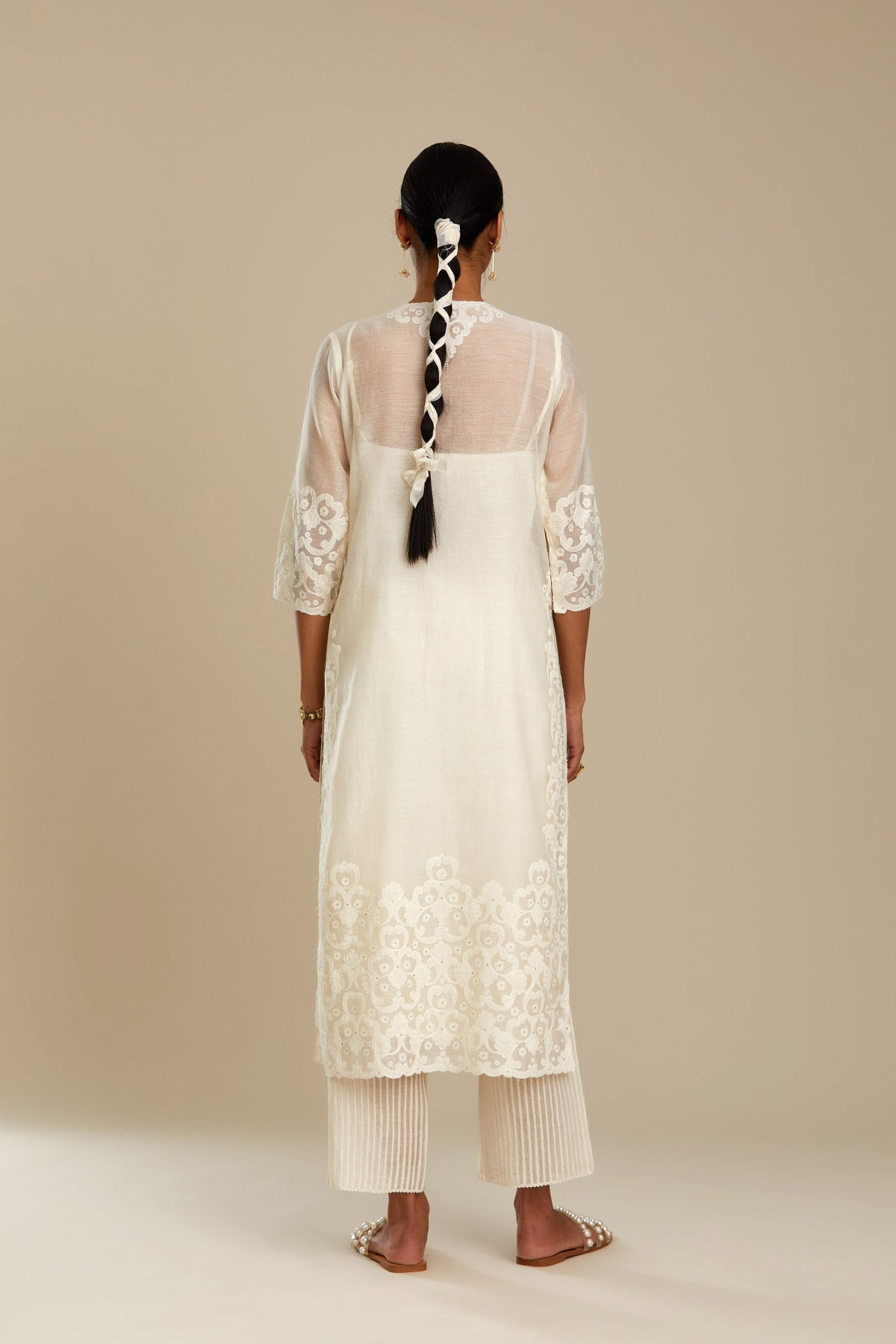 Off white cotton chanderi straight kurta set with cotton appliqué, highlighted with sequins.