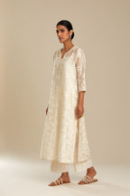 Off white silk chanderi straight kurta set with graded leaf appliqué and sequin detail at edges.