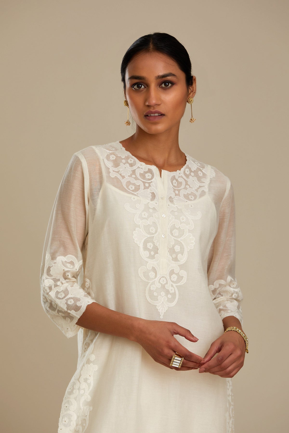 Off white cotton chanderi straight kurta set with cotton appliqué, highlighted with sequins.
