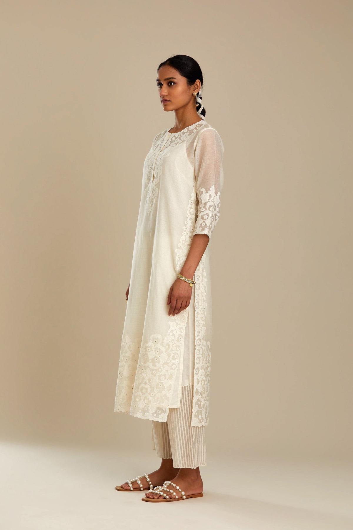 Off white cotton chanderi straight kurta set with cotton appliqué, highlighted with sequins.
