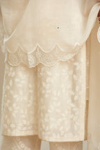 Off white silk chanderi straight kurta set with graded leaf appliqué and sequin detail at edges.