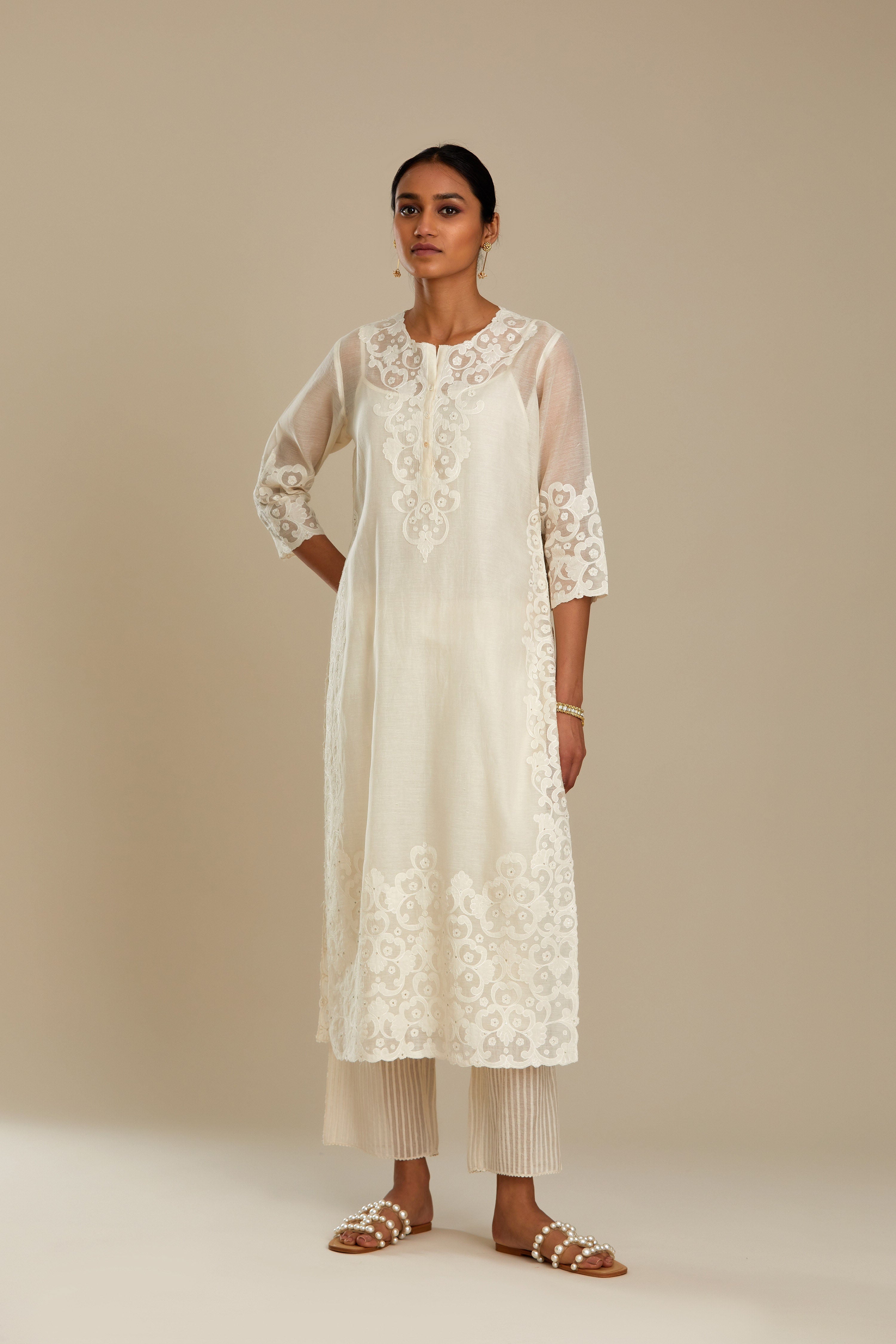 Off white cotton chanderi straight kurta set with cotton appliqué, highlighted with sequins.