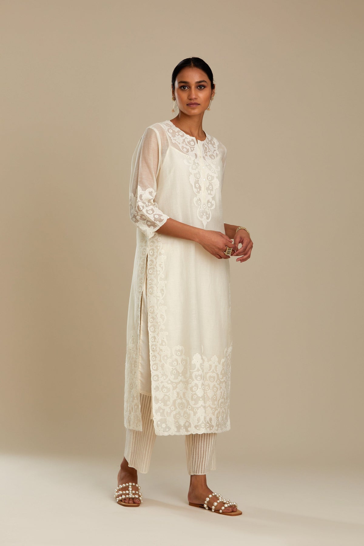 Off white cotton chanderi straight kurta set with cotton appliqué, highlighted with sequins.