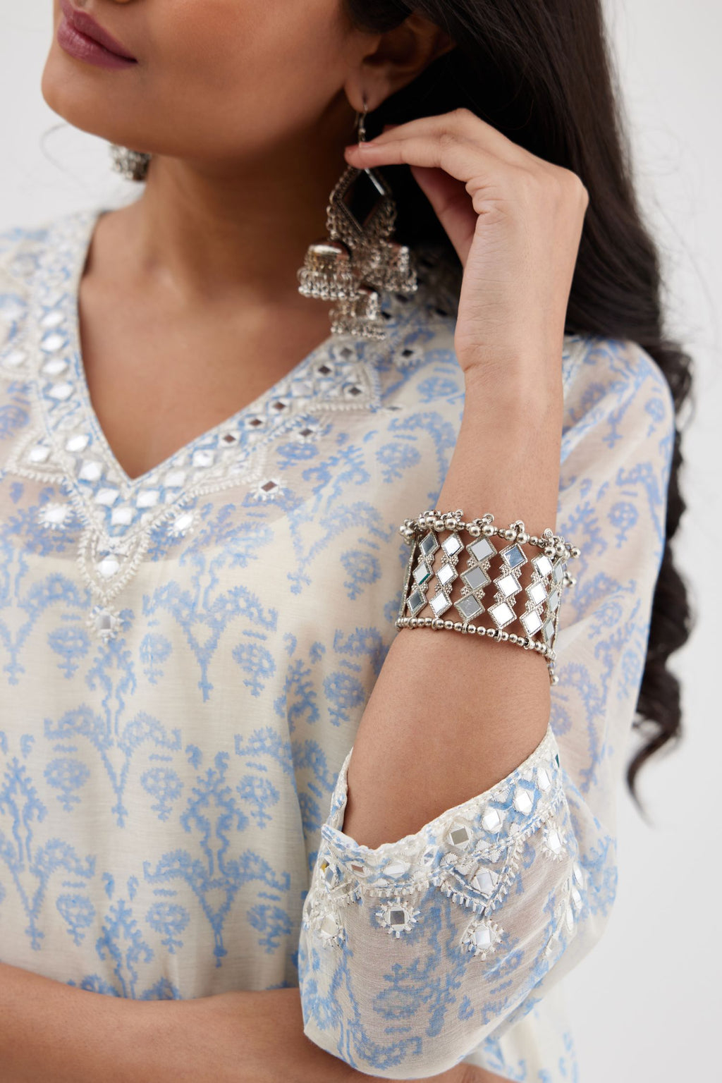 Blue and off white cotton chanderi Ikat design hand-block printed A-line short kurta set with V-neck and asymmetric hem.