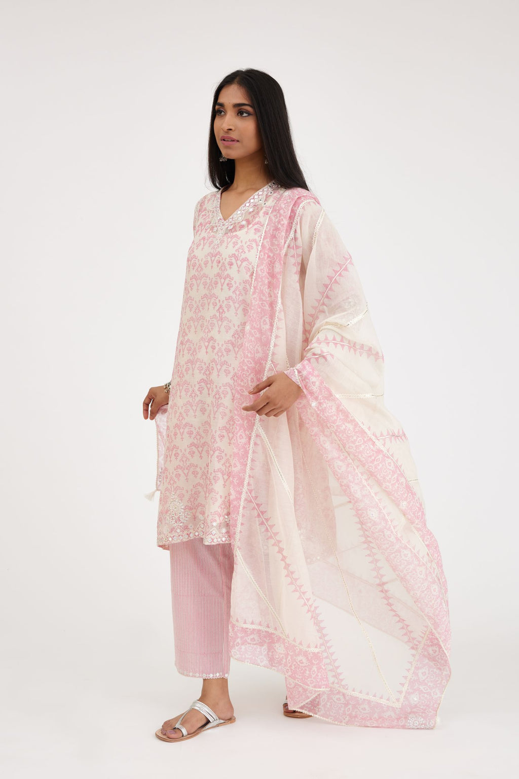 Pink and off white cotton chanderi Ikat design hand-block printed A-line short kurta set with V-neck and asymmetric hem.