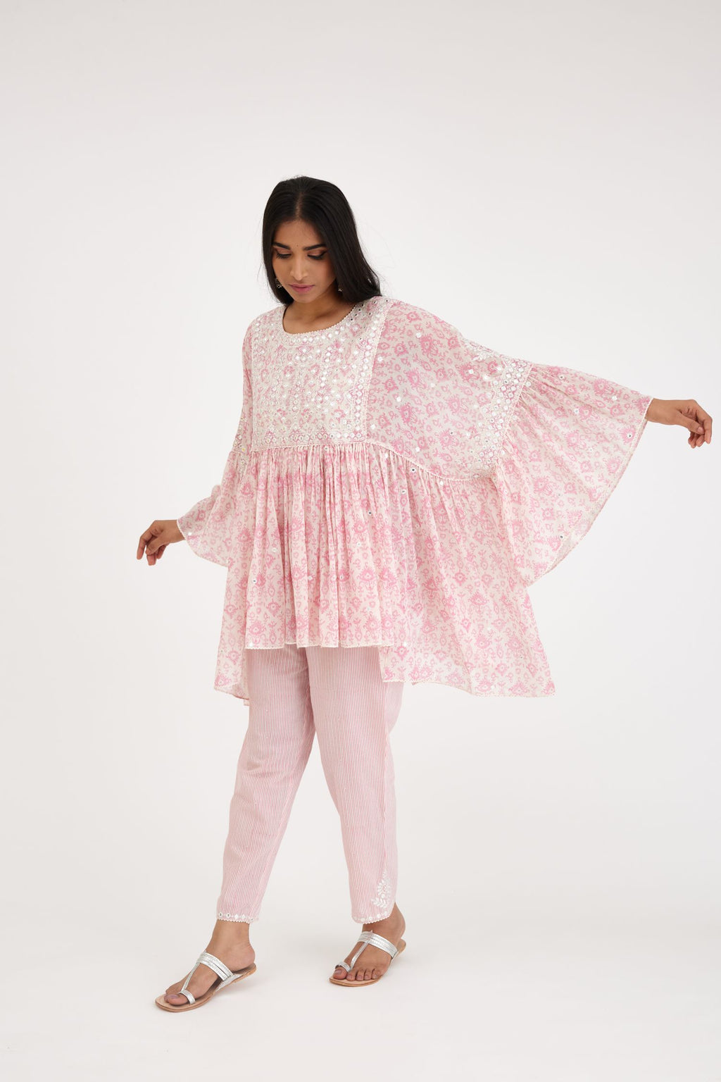 Ikat design pink and off white hand block printed cotton easy fit top with flared sleeves and hem, paired with hand-block printed striped Cotton comfortable fit pant with all-over elasticated waisband.