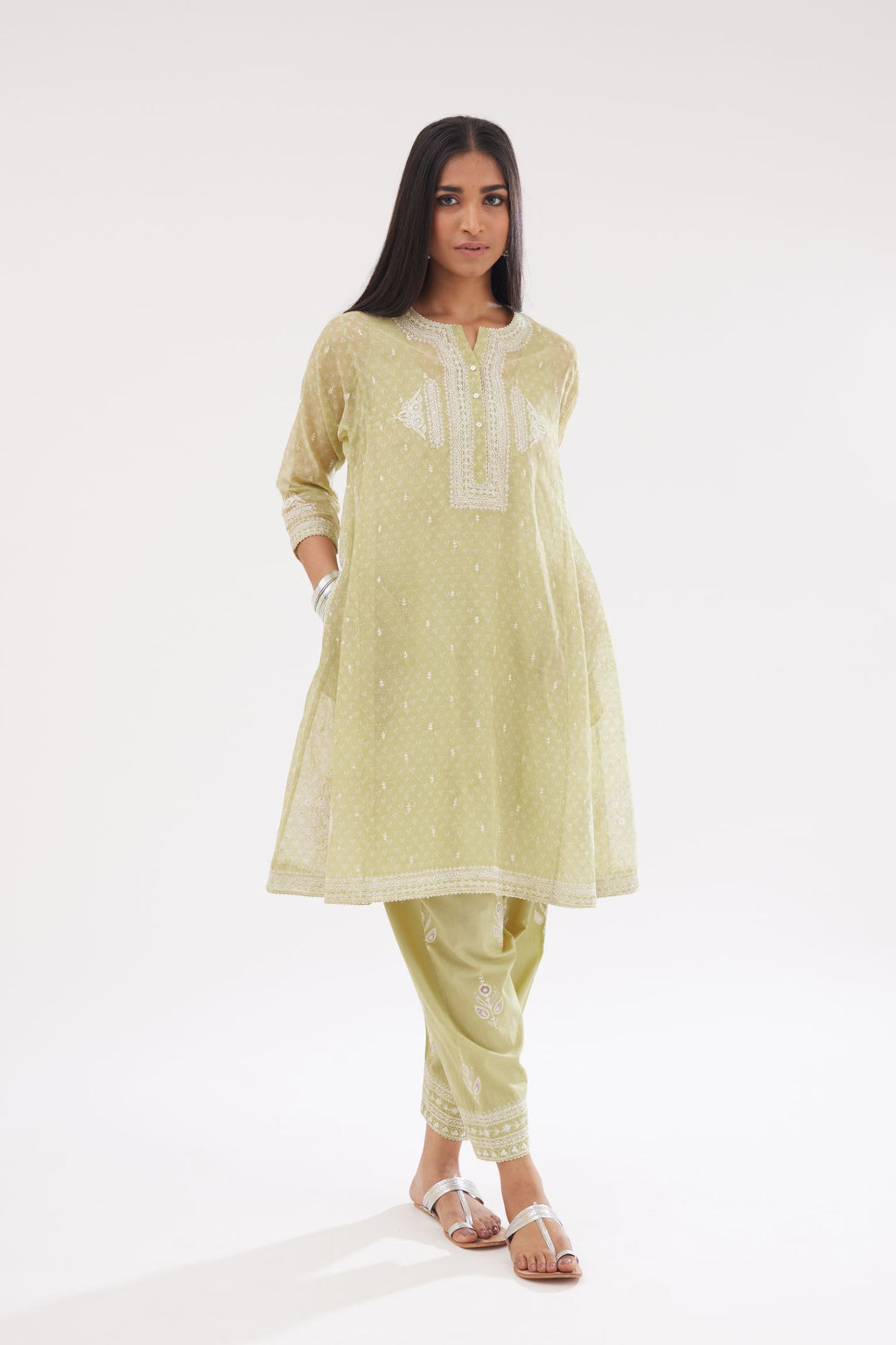 Green cotton chanderi hand block printed short kalidar phiran style kurta set with button placket neckline and dori and silk thraed embroidery all over.