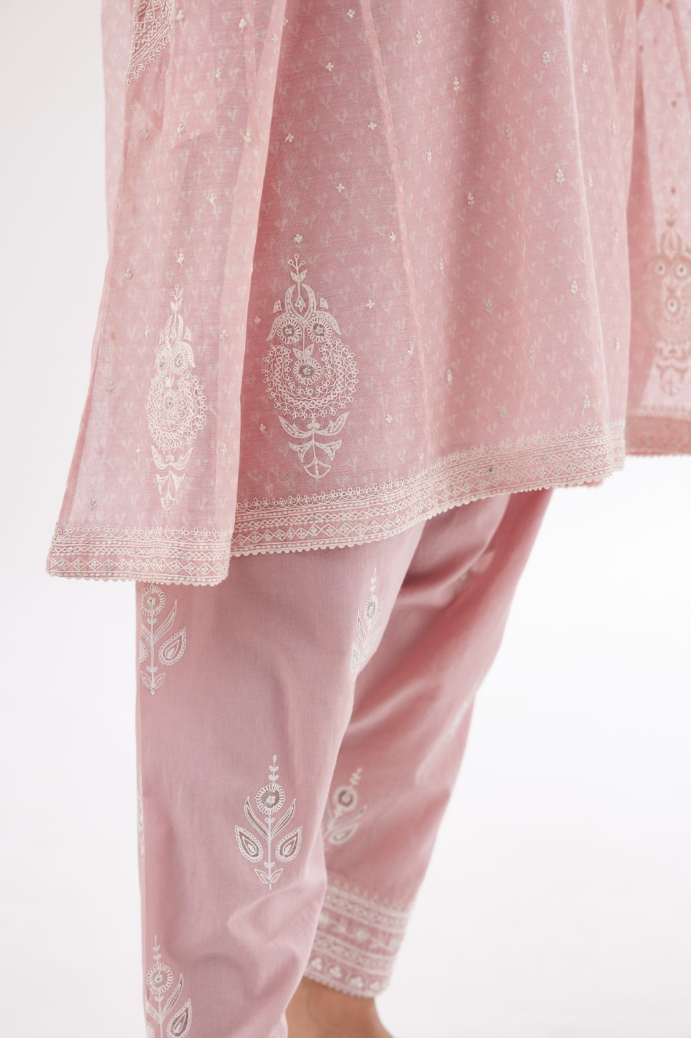 Pink cotton chanderi hand block printed short kalidar phiran style kurta set with button placket neckline and dori and silk thraed embroidery all over.