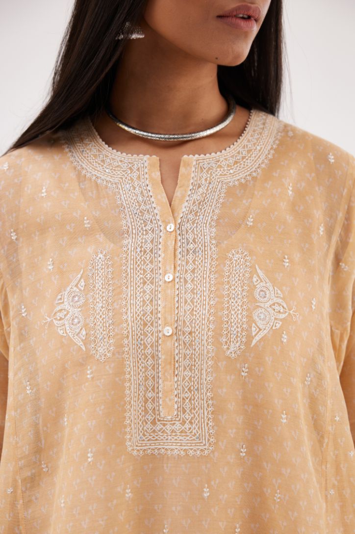 Peach cotton chanderi hand block printed short kalidar phiran style kurta set with button placket neckline and dori and silk thraed embroidery all over.