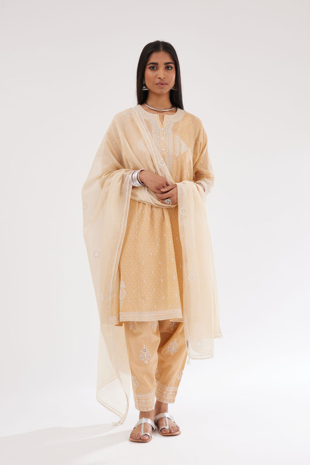 Peach cotton chanderi hand block printed short kalidar phiran style kurta set with button placket neckline and dori and silk thraed embroidery all over.