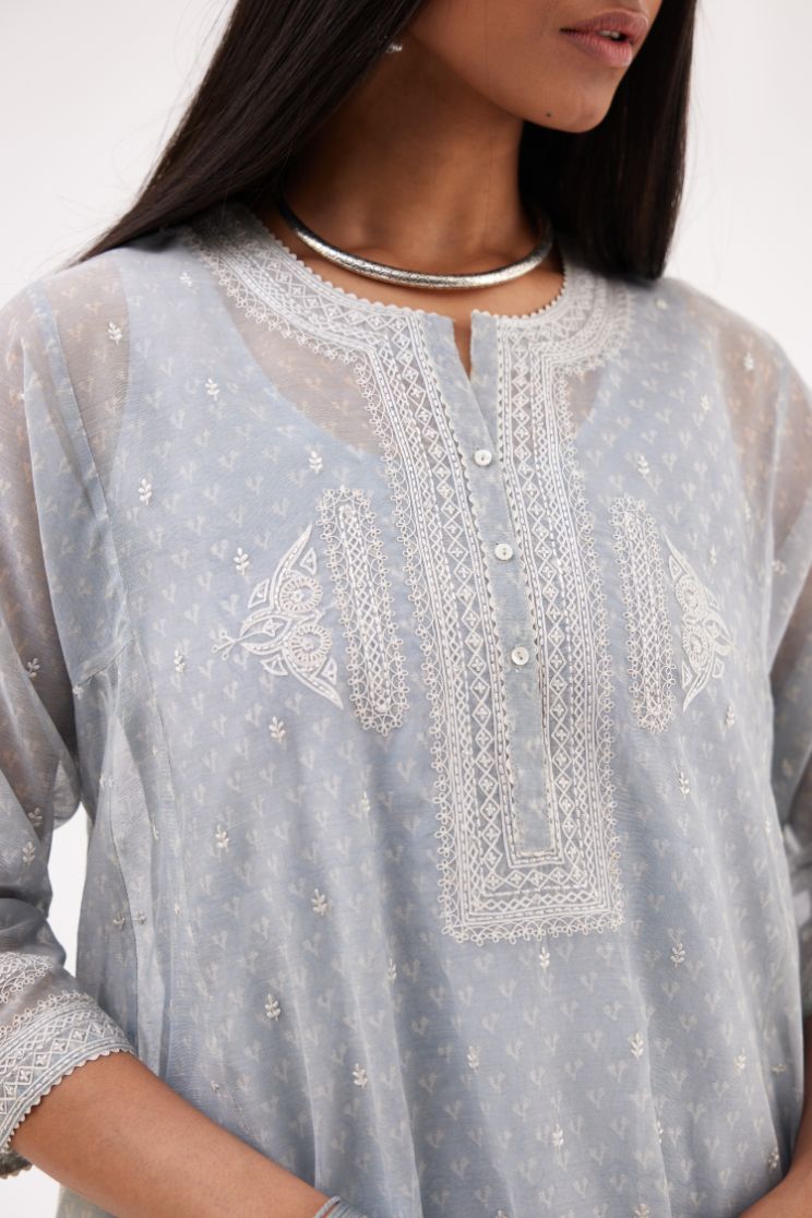Blue cotton chanderi hand block printed short kalidar phiran style kurta set with button placket neckline and dori and silk thraed embroidery all over.
