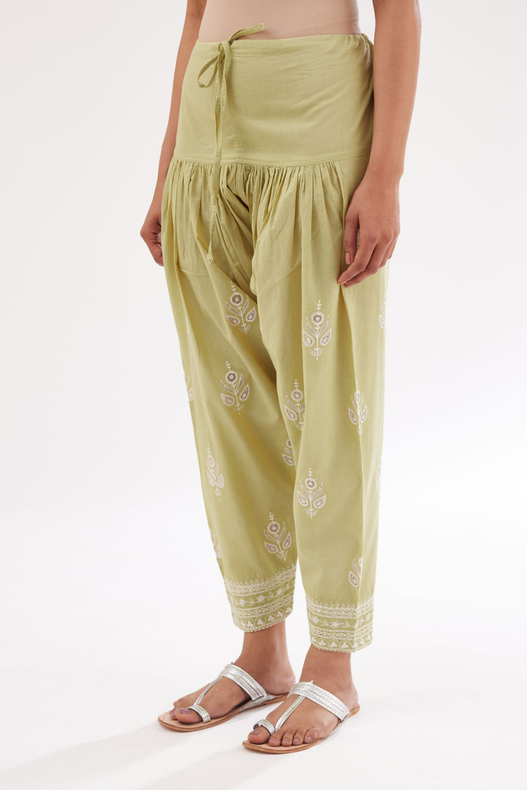 Green cotton narrow salwar with all-over dori and silk thread embroidery.