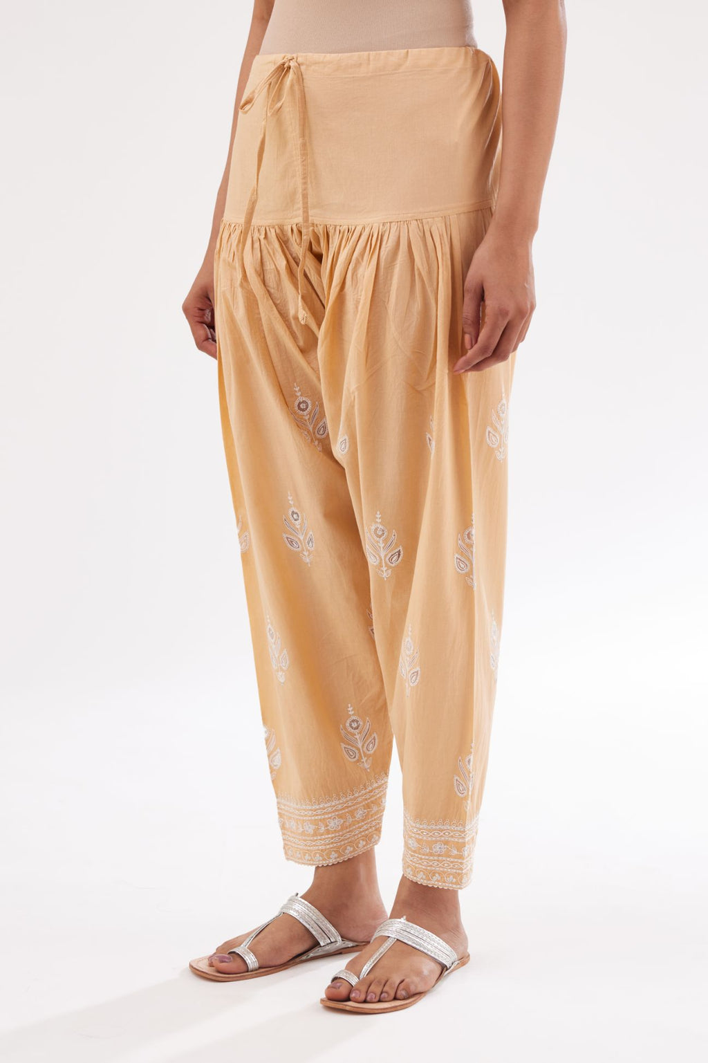 Peach cotton narrow salwar with all-over dori and silk thread embroidery.