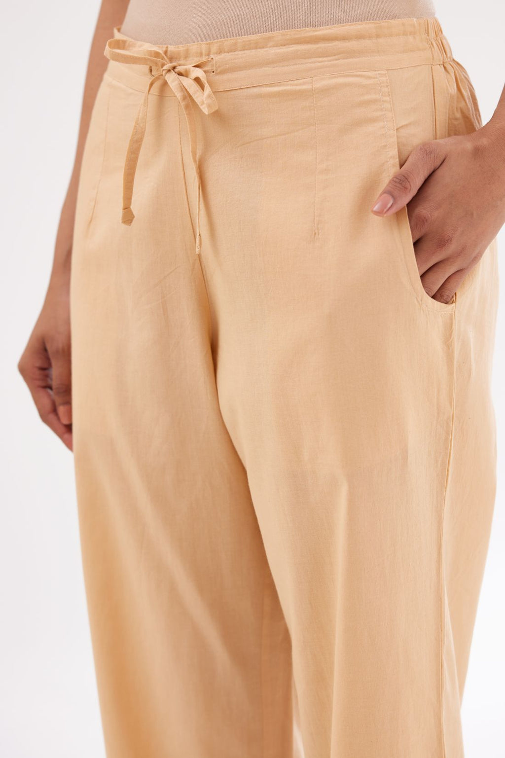 Peach cotton straight pants with appliqué and hand attached sequins detailing at bottom hem.