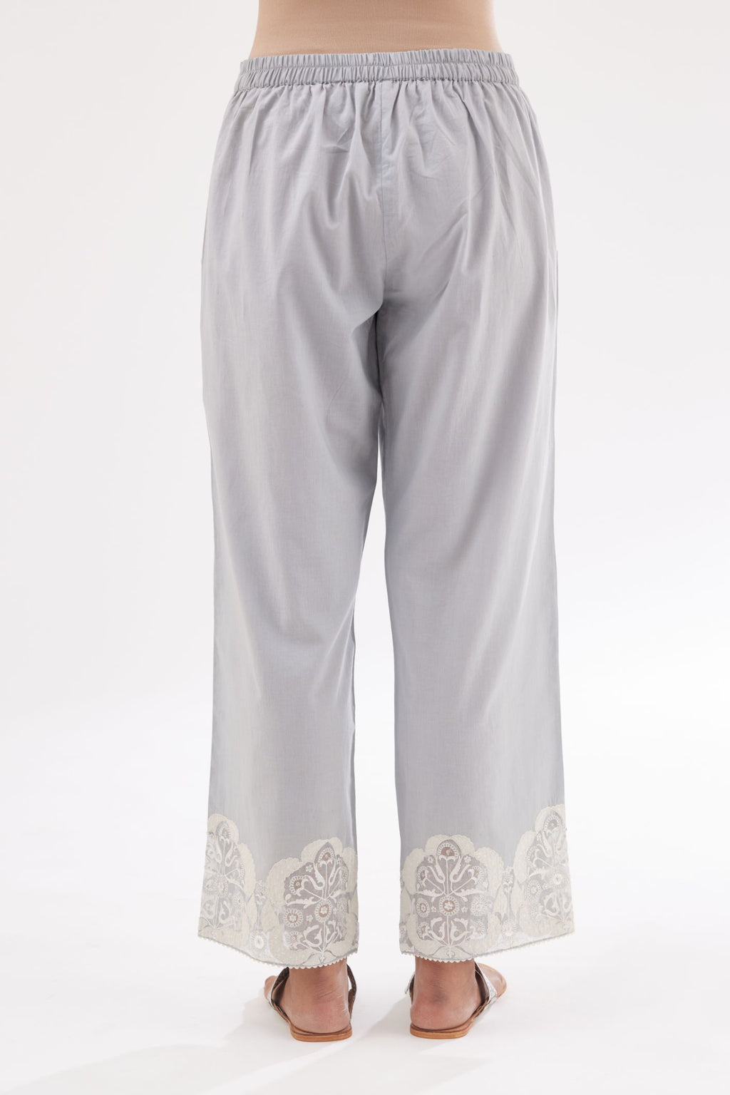 Blue cotton straight pants with appliqué and hand attached sequins detailing at bottom hem.