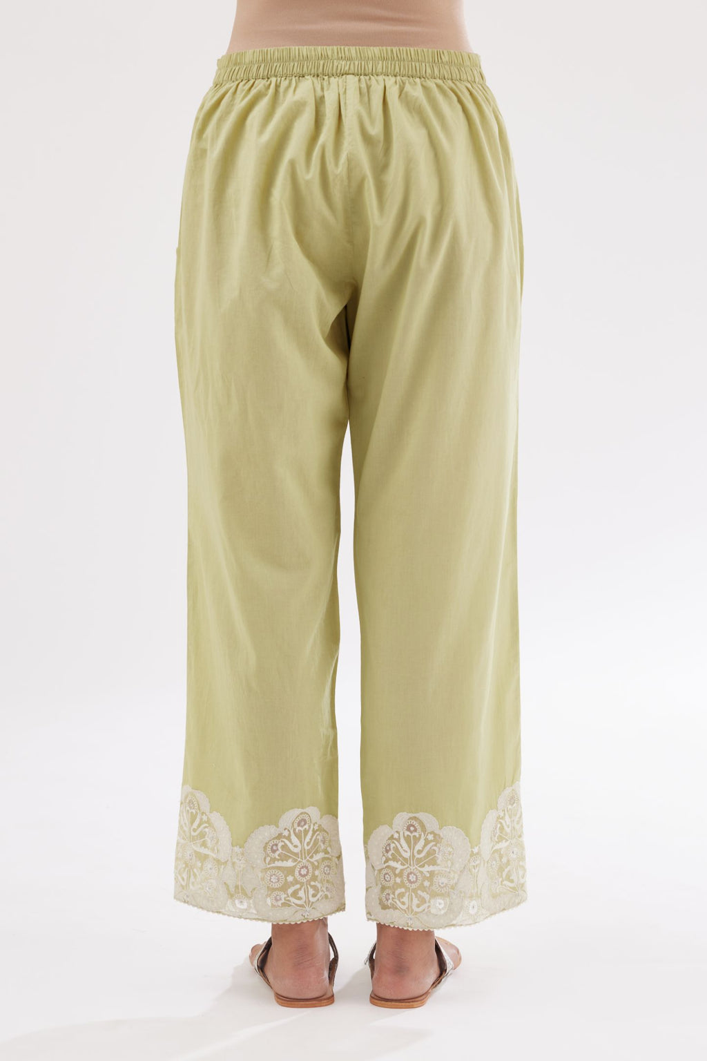 Green cotton straight pants with appliqué and hand attached sequins detailing at bottom hem.