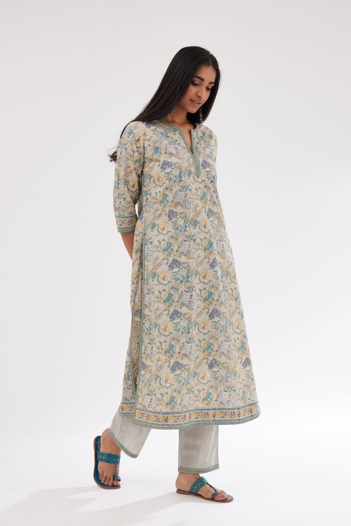 Grey and blue straight kurta with all-over chintz block print & side slits, paired with grey and blue printed stripe cotton straight pants with a narrow printed border at the hem.