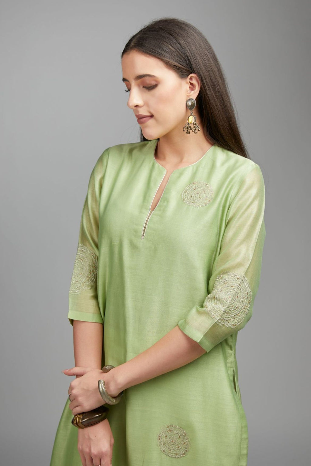 Lime green straight kurta set with gold zari embroidery in front and back.