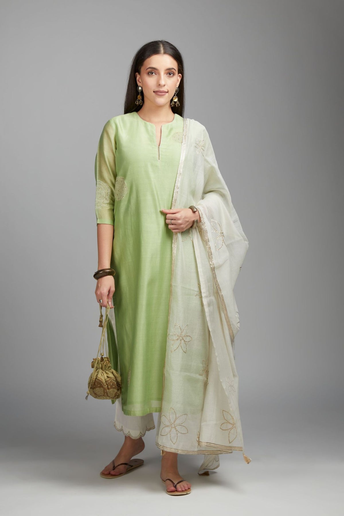 Lime green straight kurta set with gold zari embroidery in front and back.