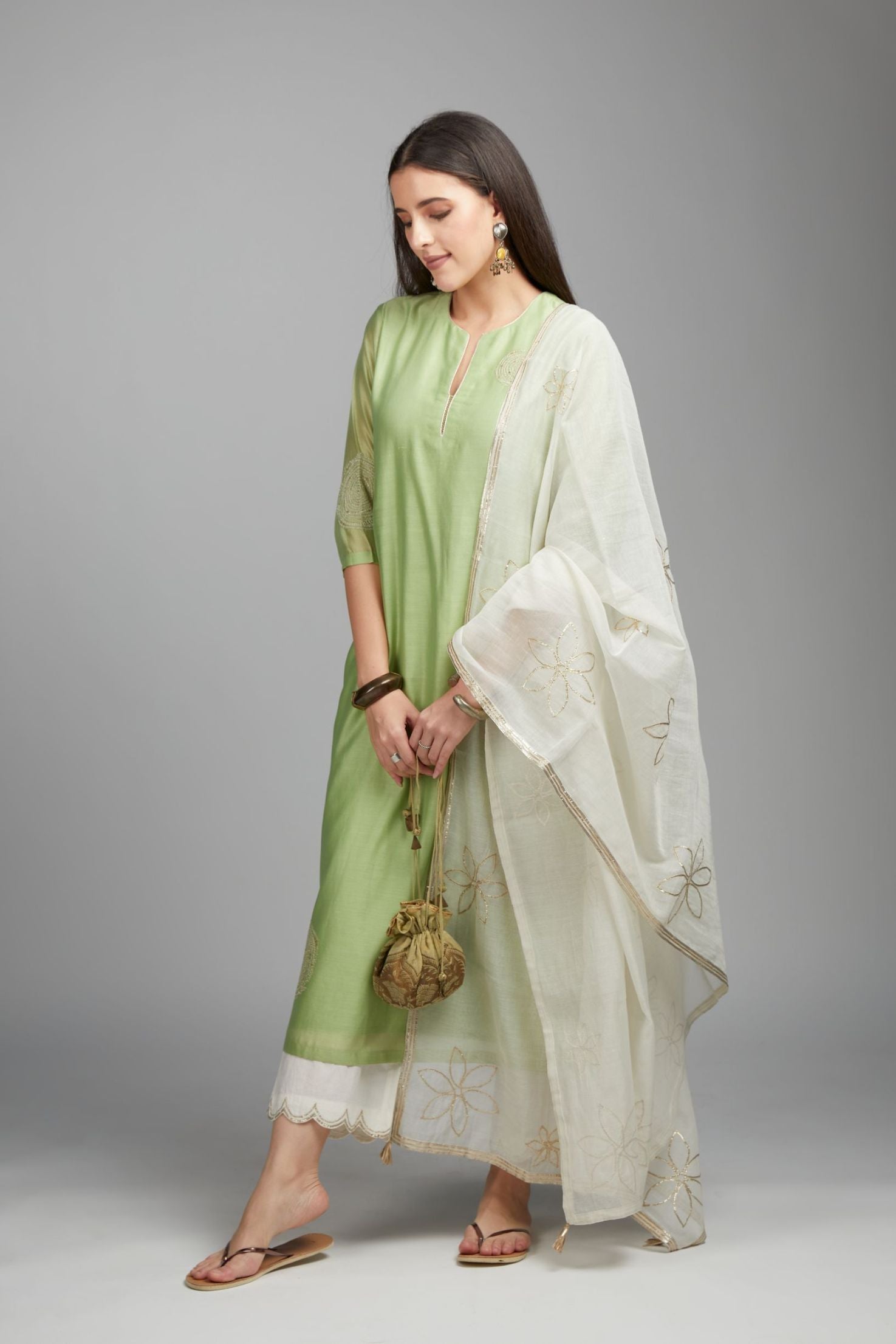 Lime green straight kurta set with gold zari embroidery in front and back.