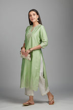 Lime green straight kurta set with silver zari embroidery at neck and scalloped hem
