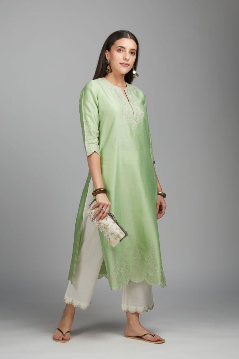 Lime green straight kurta set with silver zari embroidery at neck and scalloped hem