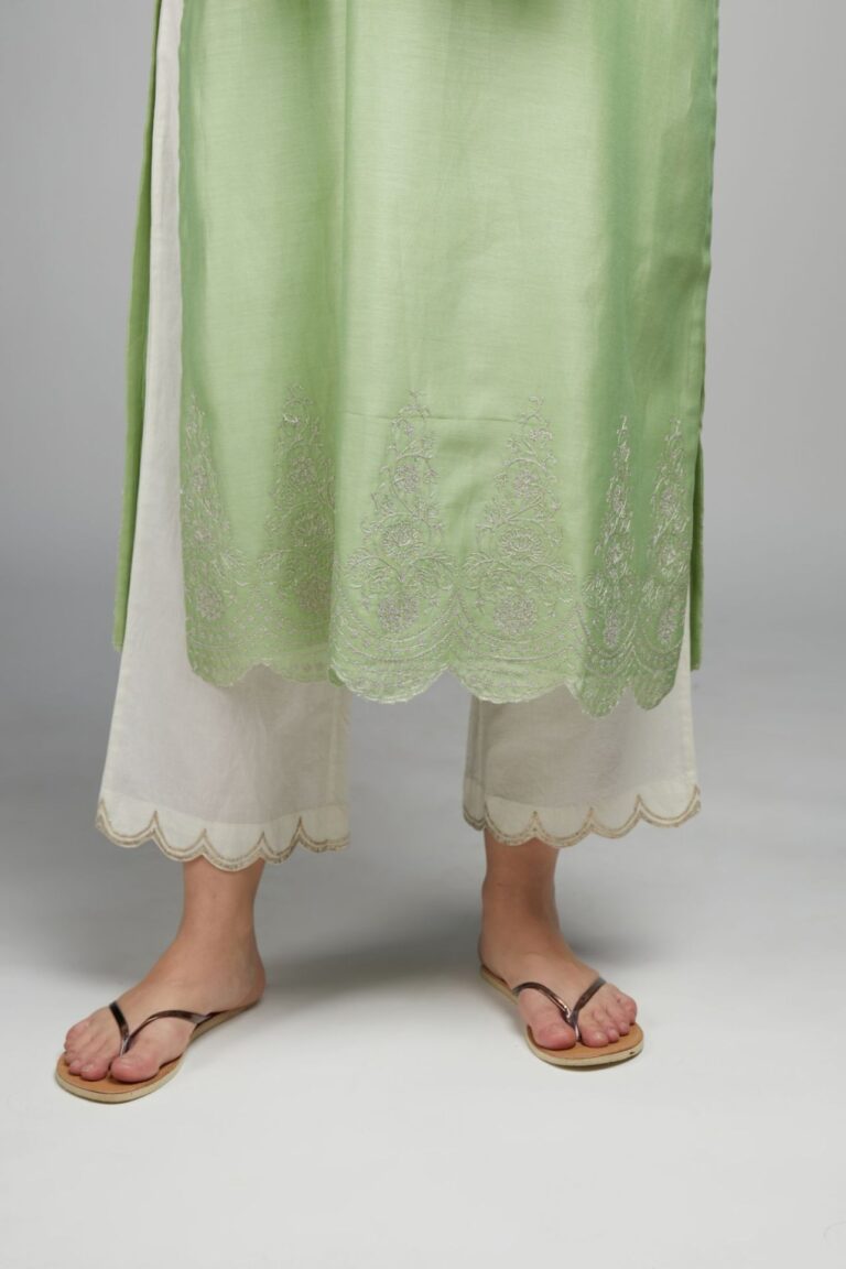 Lime green straight kurta set with silver zari embroidery at neck and scalloped hem