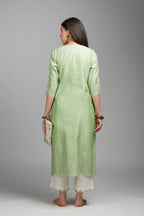 Lime green straight kurta set with silver zari embroidery at neck and scalloped hem