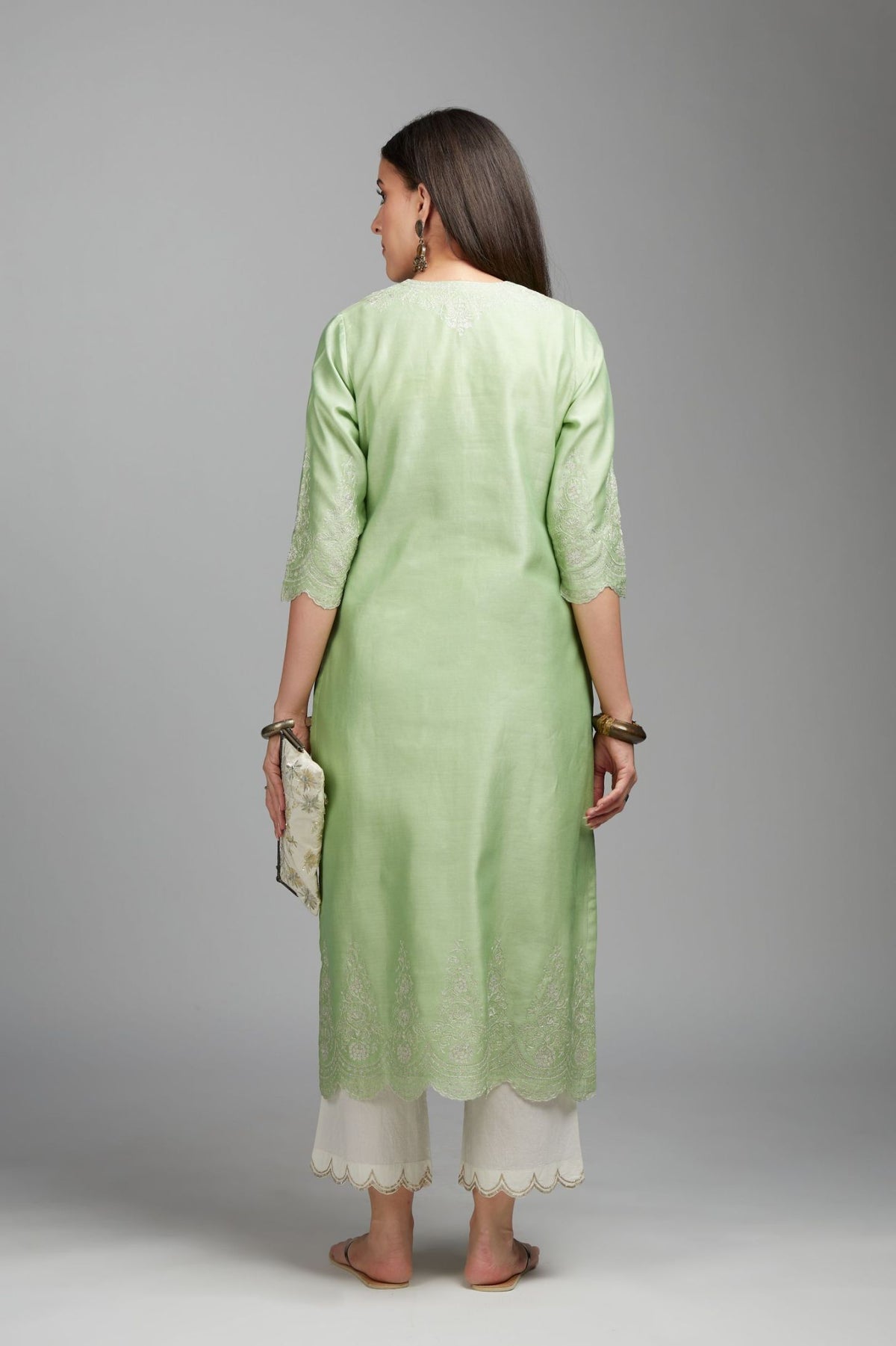 Lime green straight kurta set with silver zari embroidery at neck and scalloped hem
