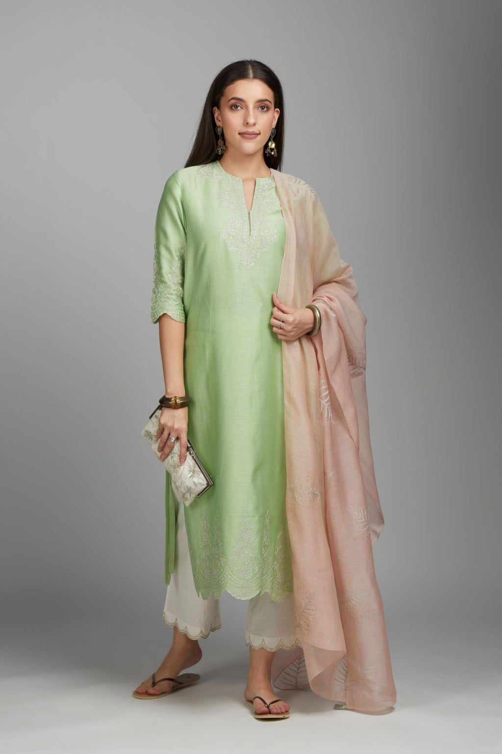 Lime green straight kurta set with silver zari embroidery at neck and scalloped hem
