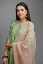 Lime green straight kurta set with silver zari embroidery at neck and scalloped hem