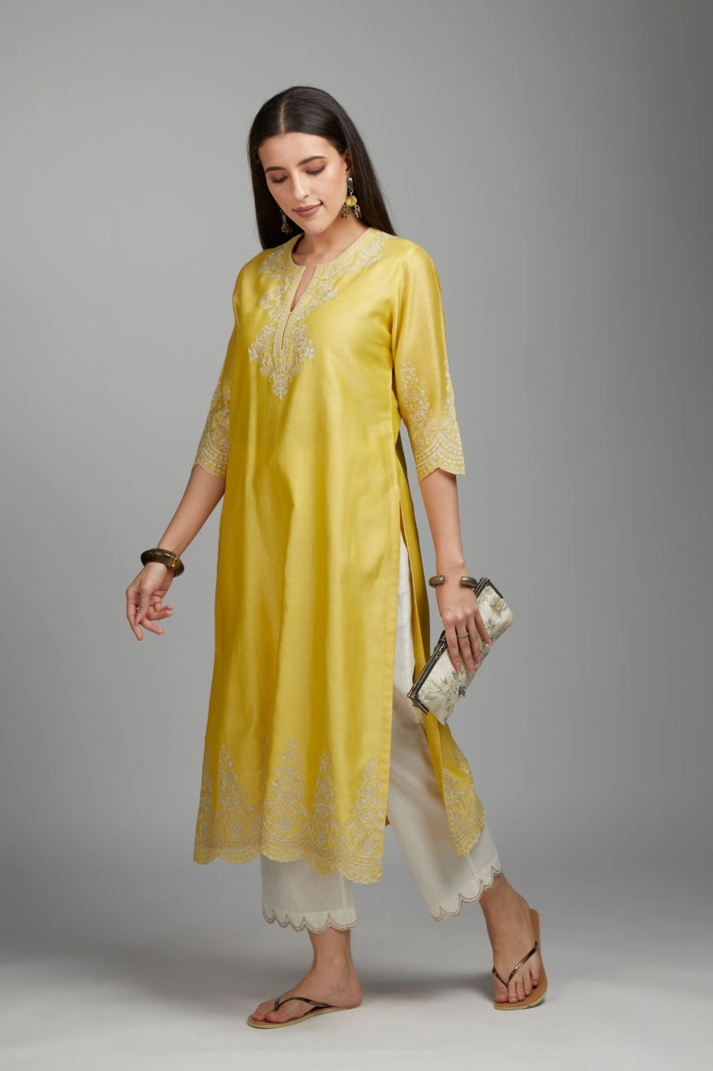 Yellow straight kurta set with silver zari embroidery at neck and scalloped hem
