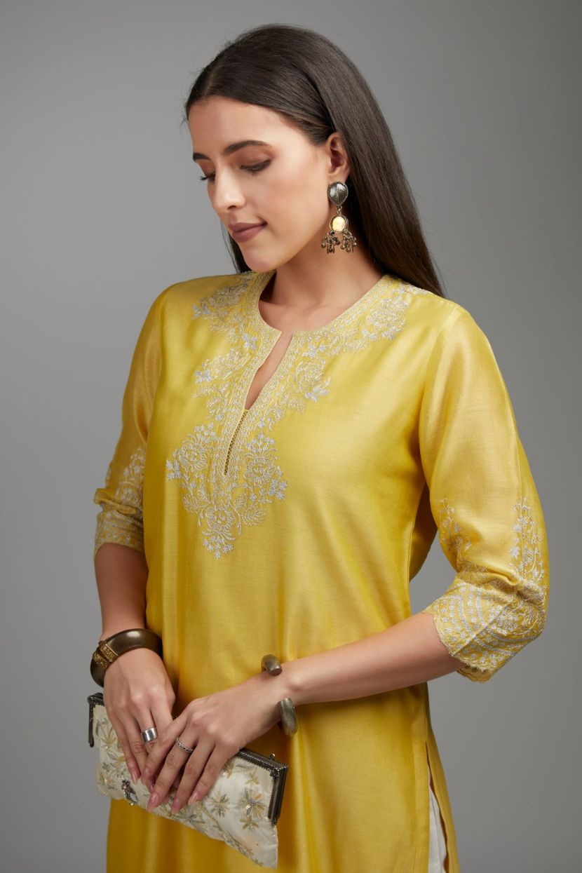 Yellow straight kurta set with silver zari embroidery at neck and scalloped hem