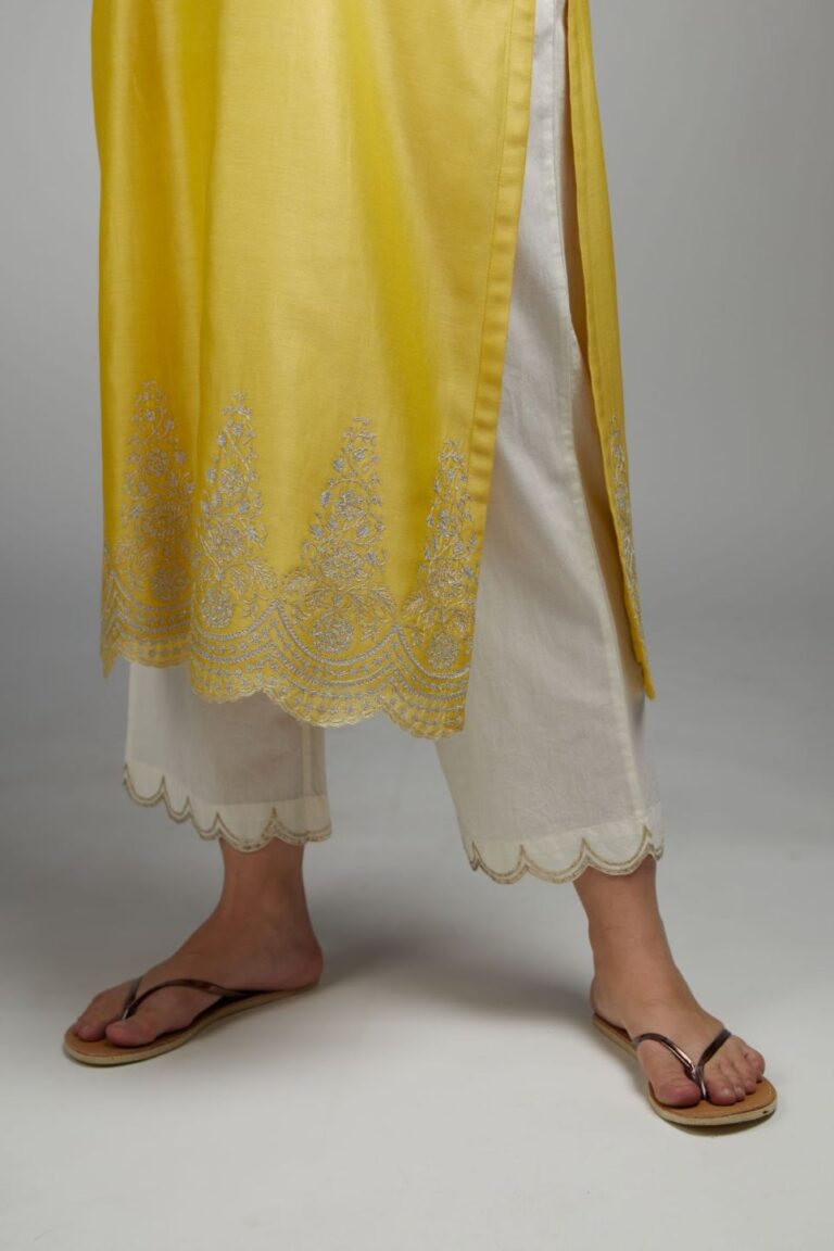Yellow straight kurta set with silver zari embroidery at neck and scalloped hem