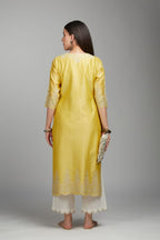 Yellow straight kurta set with silver zari embroidery at neck and scalloped hem