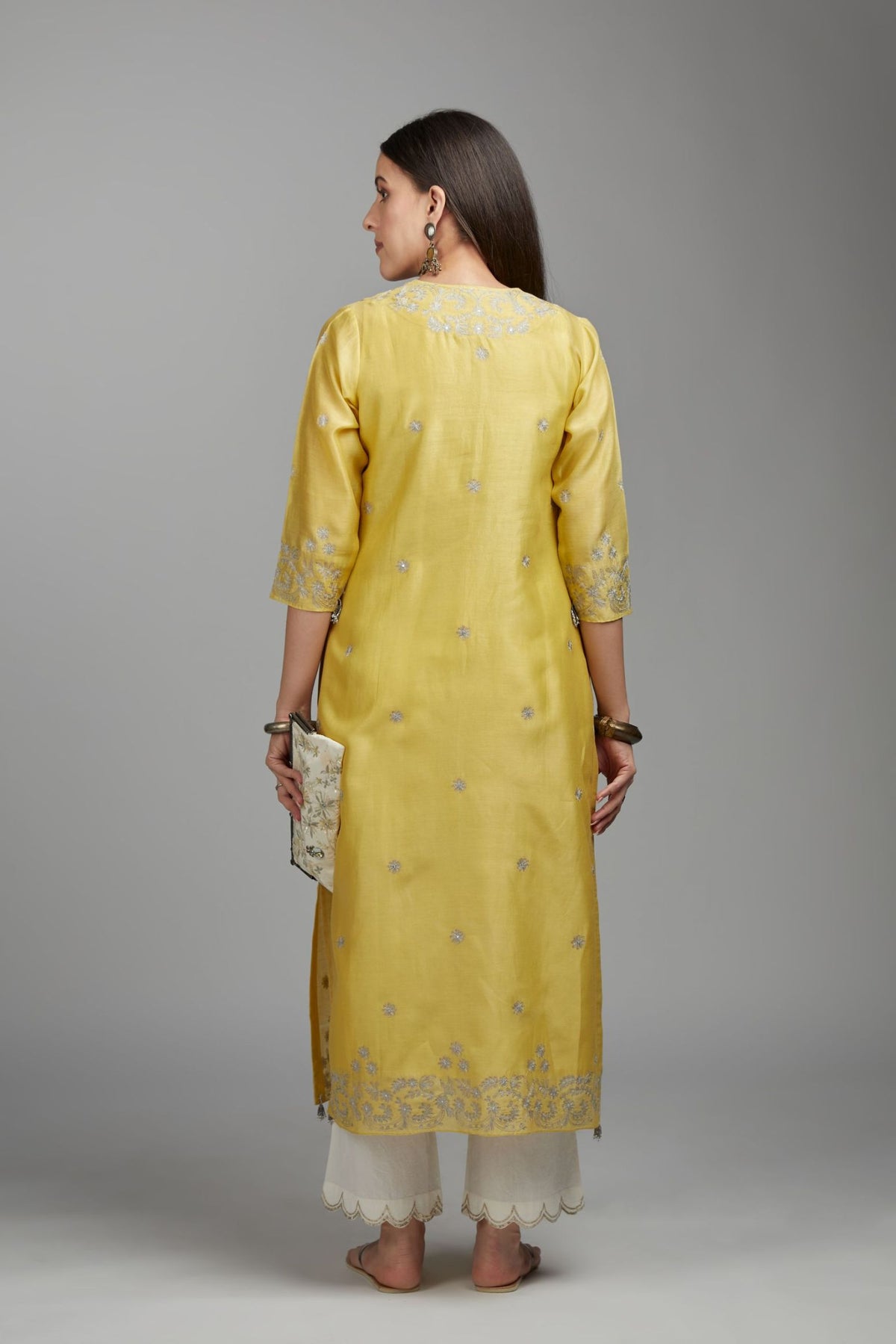Yellow straight kurta set with silver zari embroidery and round neckline with button placket in the front