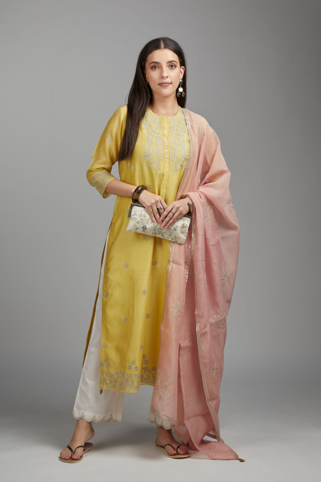 Yellow straight kurta set with silver zari embroidery and round neckline with button placket in the front